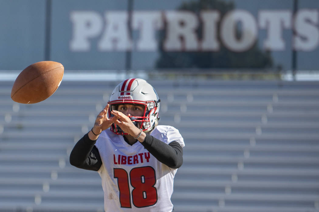 Liberty's quarterback Daniel Britt (18) is about to catch the ball during practice on Tuesday, ...