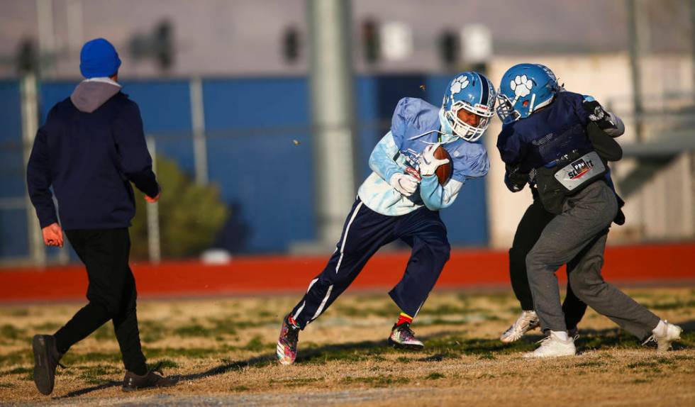 Centennial's Giovanni Monroe runs the ball during football practice at Centennial High School i ...