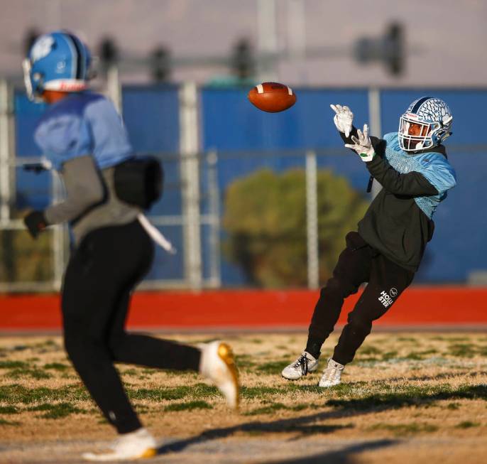 Centennial's Aaron Johnson reaches for a reception during football practice at Centennial High ...