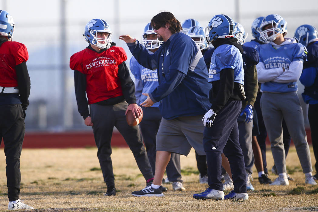 Centennial football coach Dustin Forshee, right, motions in front of quarterback Colton Tenney, ...