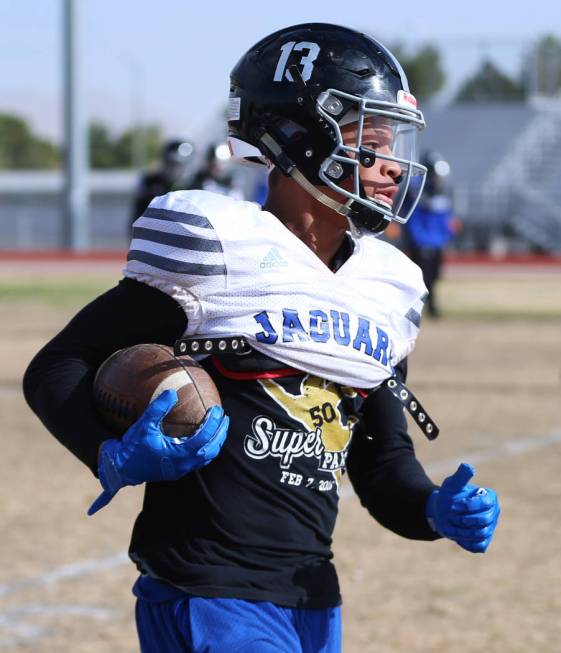 Desert Pines' Michael Jackson (13) returns a punt during a team practice at Desert Pines High S ...