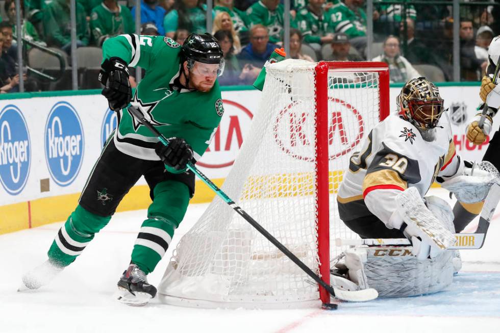 Dallas Stars center Radek Faksa (12) takes a wraparound shot-attempt as Vegas Golden Knights go ...