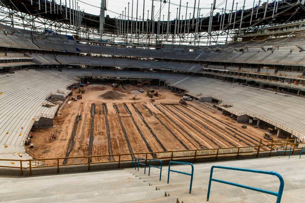 Crews continue on the arena floor during a tour of the Raiders Allegiant Stadium construction s ...