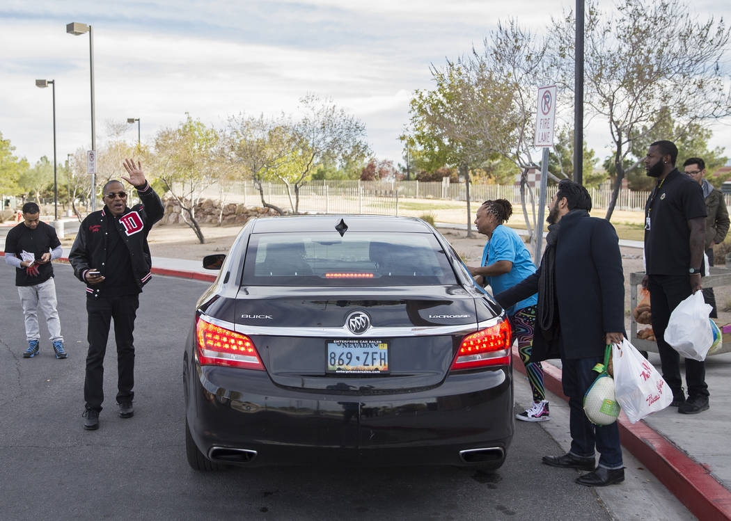 Clark County Commission Vice Chairman Lawrence Weekly, second from left, waves to friends while ...