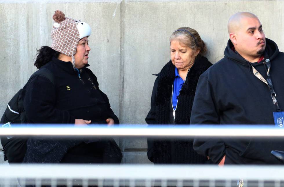 Commuters are bundled up as they wait for the bus in cold weather on Wednesday, Nov. 27, 2019, ...