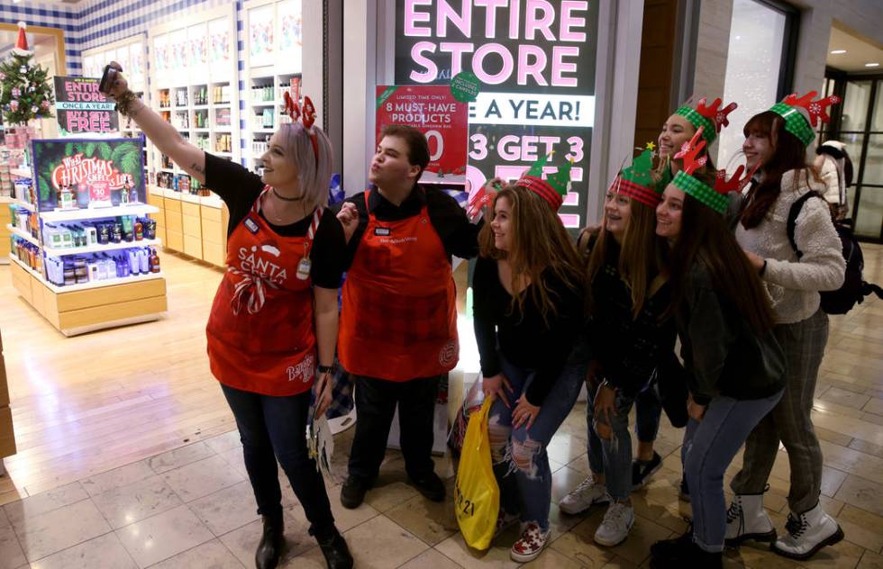 Bath & Body Works employees Samantha Pierce and Anthony Paz pose with, from third from left ...