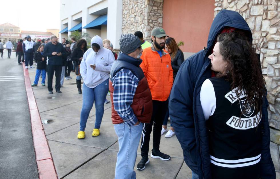 Heather Vidal stays warm in line with her boyfriend Von Spencer at Best Buy at 6455 N. Decatur ...