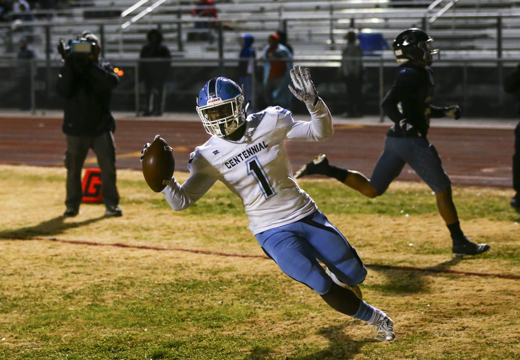 Centennial's Jordan Smith (1) scores a touchdown against Desert Pines during the first half of ...