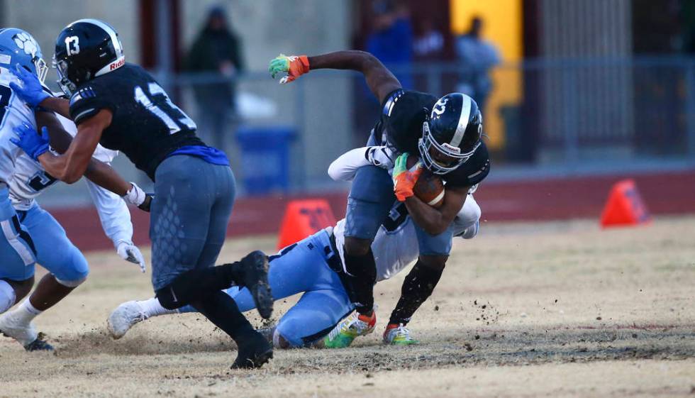 Centennial's Donte Washington (3) stops Desert Pines' Javontae Barnes (22) during the first hal ...