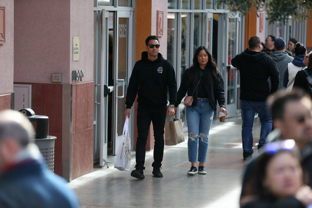 Gregory Lee, left, and his wife, Jamie, of Los Angeles, shop at Las Vegas Premium Outlets North ...