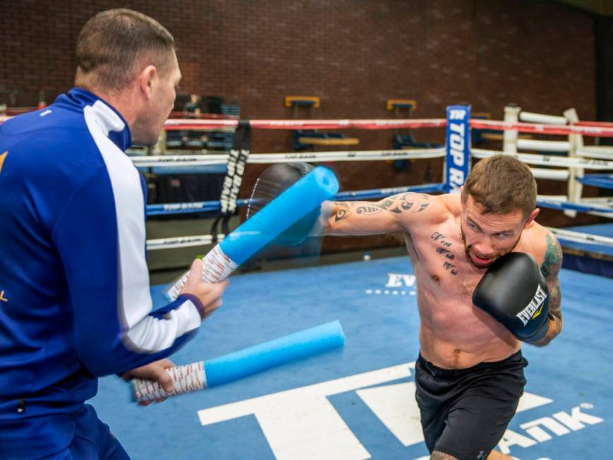 Former two-weight world boxing champion Carl Frampton, right, boxes with trainer Jamie Moore at ...