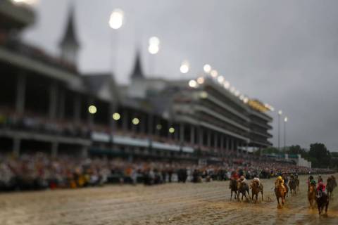 In this photo made with a tilt shift lens, Luis Saez rides Maximum Security across the finish l ...