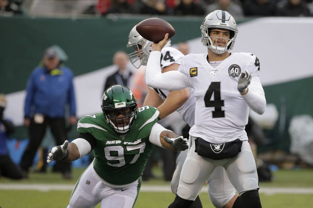 Oakland Raiders quarterback Derek Carr (4) throws a pass away from New York Jets' Nathan Shephe ...