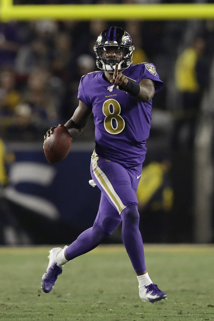 Baltimore Ravens quarterback Lamar Jackson runs against the Los Angeles Rams during the second ...