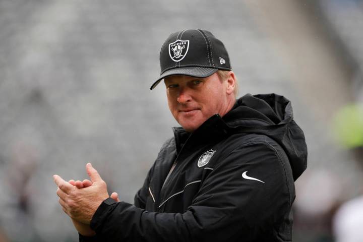 Oakland Raiders head coach Jon Gruden watches his team warm up before an NFL football game agai ...