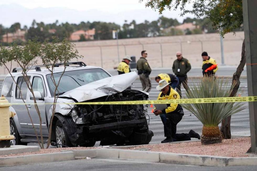 Las Vegas police officers investigate a fatal crash at Durango Drive and Russell Road in southw ...