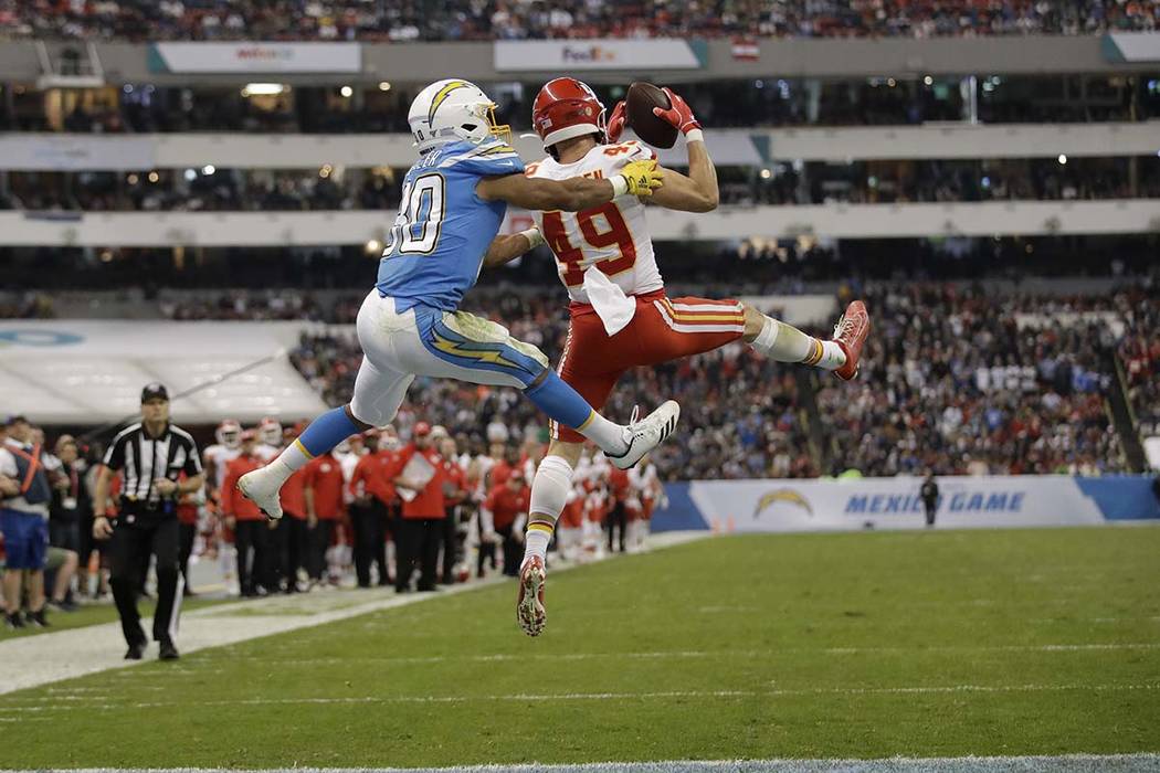 Kansas City Chiefs defensive back Daniel Sorensen, right, intercepts a pass intended for Los An ...