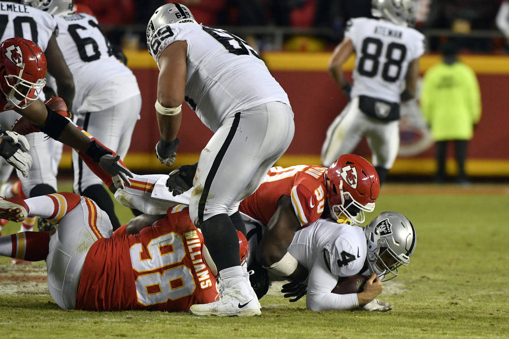 Kansas City Chiefs linebacker Justin Houston (50) sacks Oakland Raiders quarterback Derek Carr ...