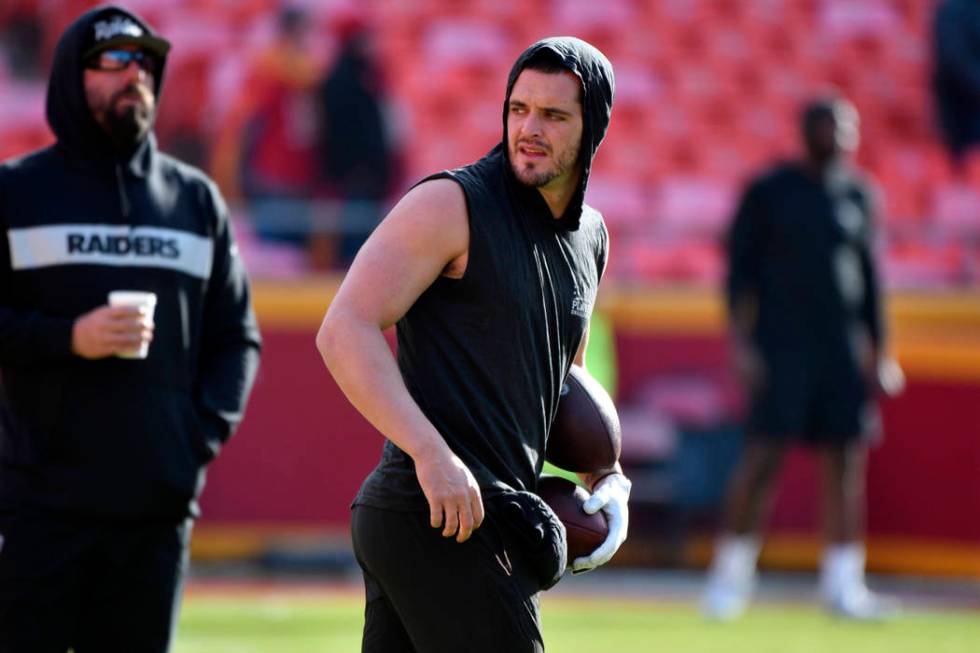 Oakland Raiders quarterback Derek Carr (4) warms up before an NFL football game against the Kan ...