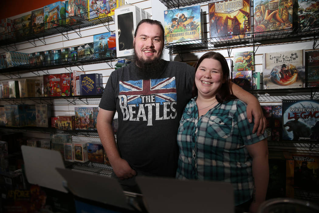 Ryan Champion, left, with his wife Allie Duda, co-owners of The Gaming Goat, pose inside their ...