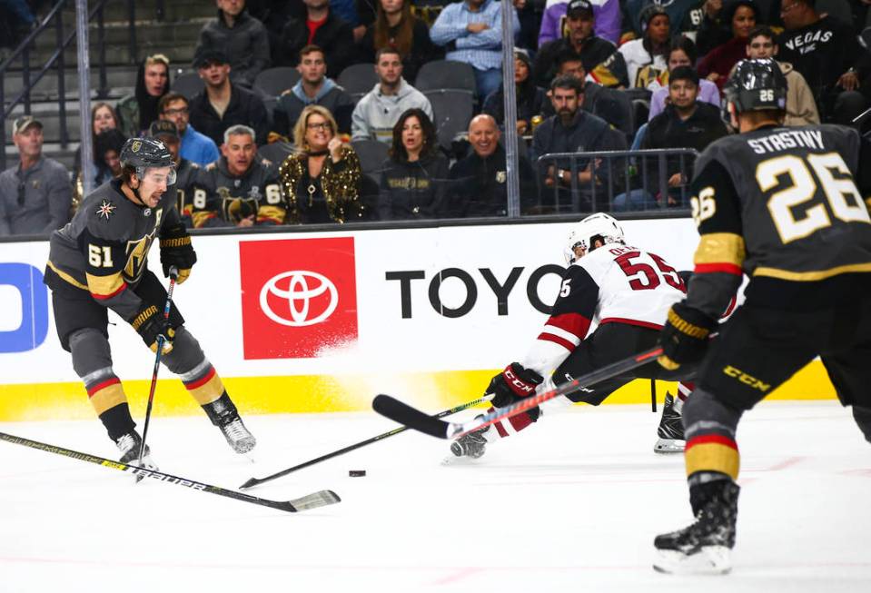 Golden Knights' Mark Stone (61) sends the puck past Arizona Coyotes' Jason Demers (55) during t ...