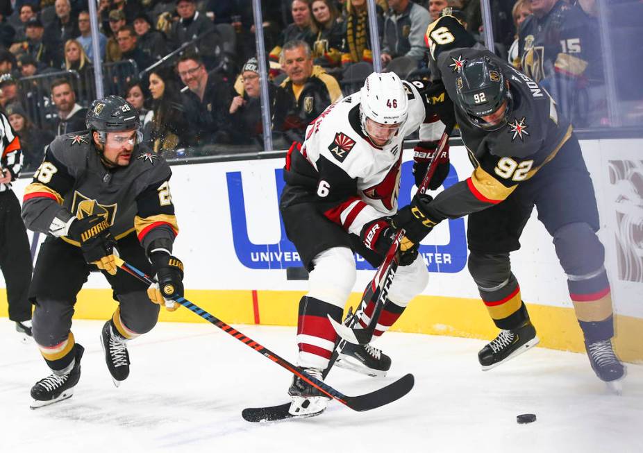 Golden Knights' Tomas Nosek (92) battles for the puck against Arizona Coyotes' Jakob Chychrun ( ...