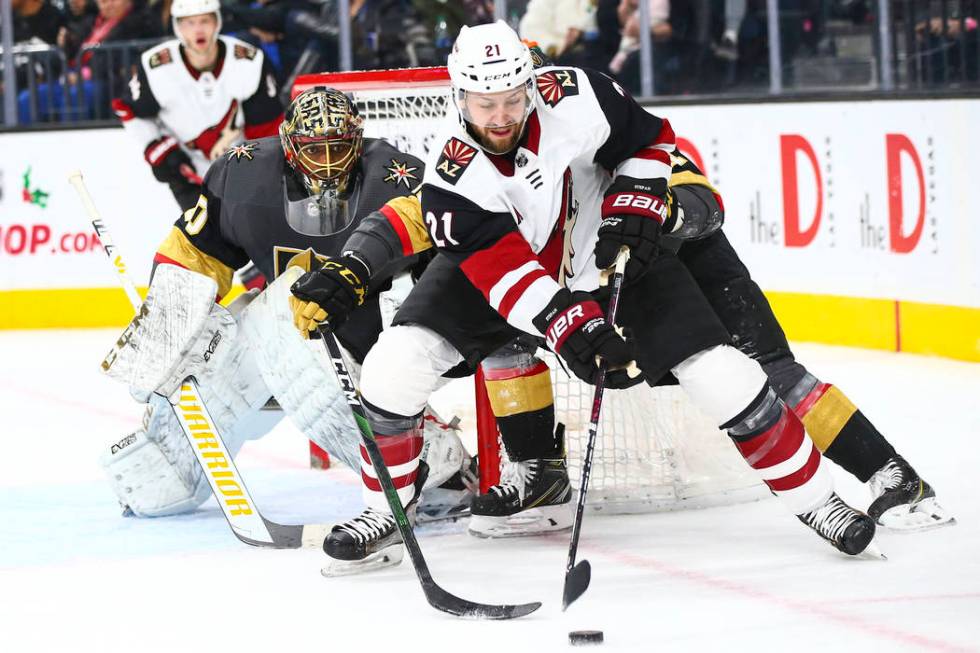 Arizona Coyotes' Derek Stepan (21) moves the puck as Golden Knights goaltender Malcolm Subban ( ...