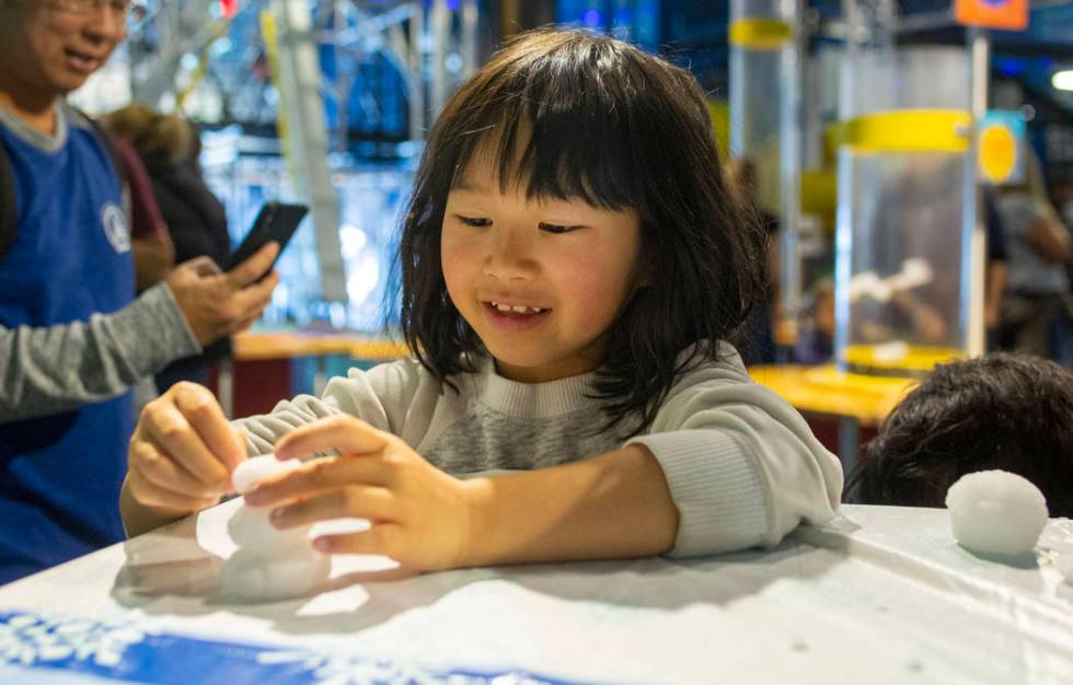 Audrey Chen, 7, of San Fransisco, makes a miniature snowman at theʄiscovery Children's Mu ...