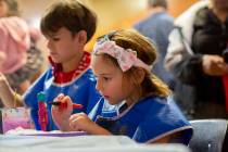 Harley Taylor, 5, of Las Vegas, paints a nutcracker ornament at Discovery Children's Museum's e ...