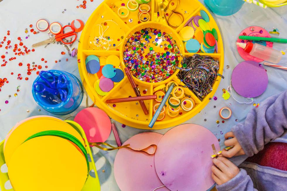 Kids make paper lollipops at a craft station during the Discovery Children's Museum's eighth an ...