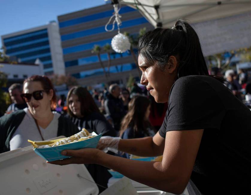 Rosa Anaya, right, of Gourmet Tamales, serves tamales at the Las Vegas Tamale & Mariachi Fe ...