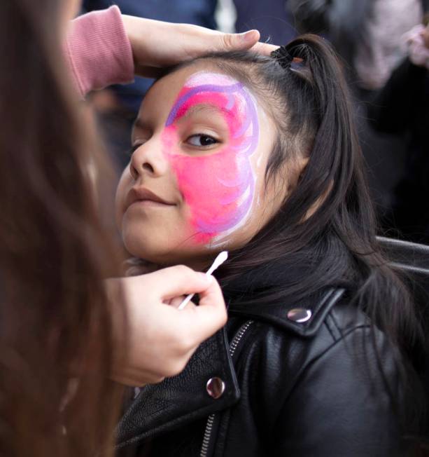 Violet Hernandez, 5, has a butterfly mask painted on her face at the Las Vegas Tamale & Mar ...