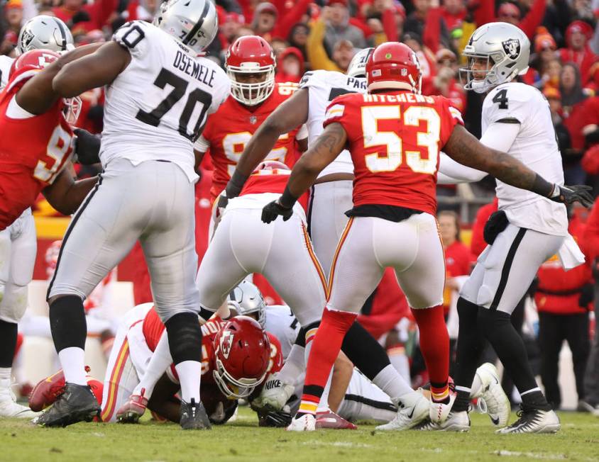 Kansas City Chiefs outside linebacker Justin Houston (50), below, intercepts Oakland Raiders qu ...