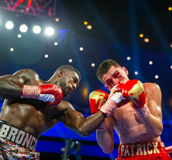 Carlos Adames, left, punches Patrick Teixeira during round 5 in their super welterweight fight ...