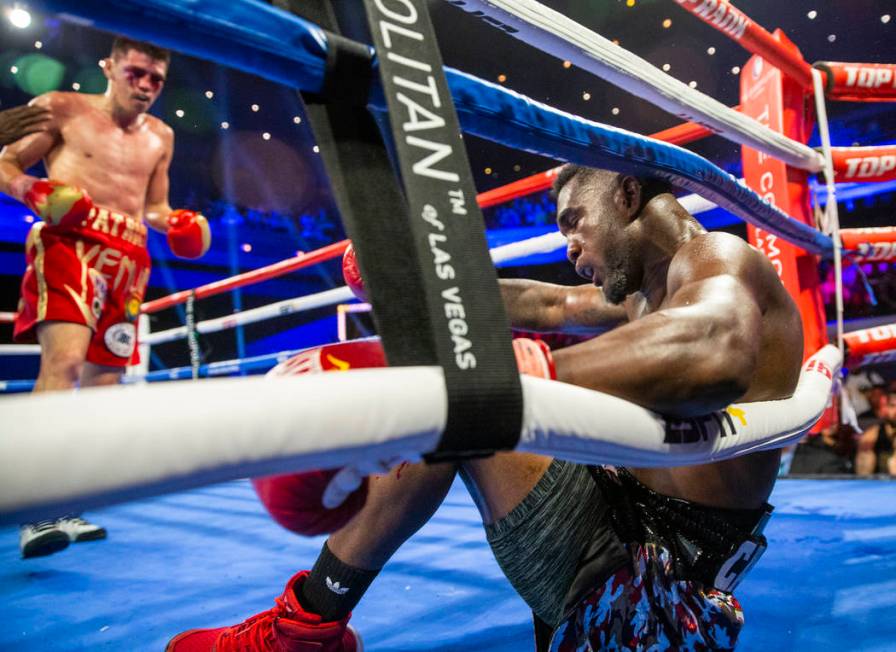 Patrick Teixeira, left, knocks down Carlos Adames during round 7 in their super welterweight fi ...