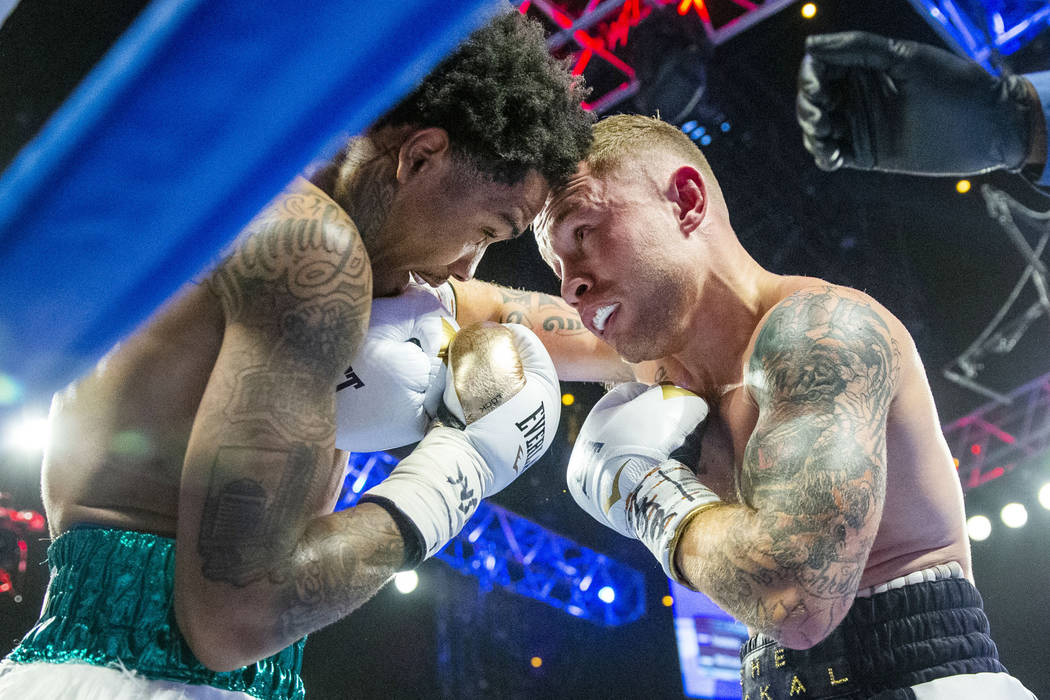 Tyler McCreary, left, takes a hit from Carl Frampton during round 4 of their WBC super featherw ...