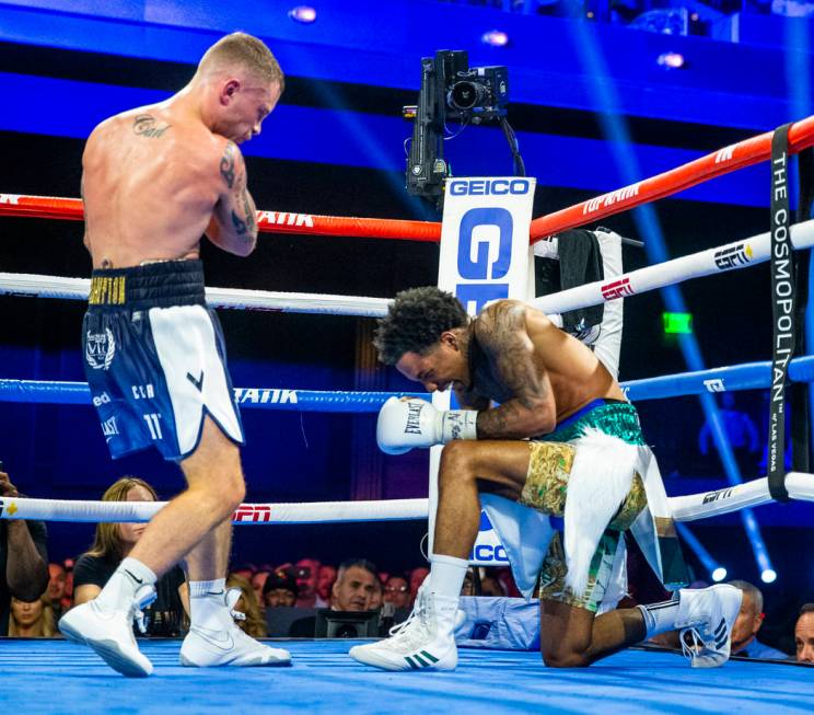 Carl Frampton, left, sends Tyler McCreary to a knee again during round 9 of their WBC super fe ...