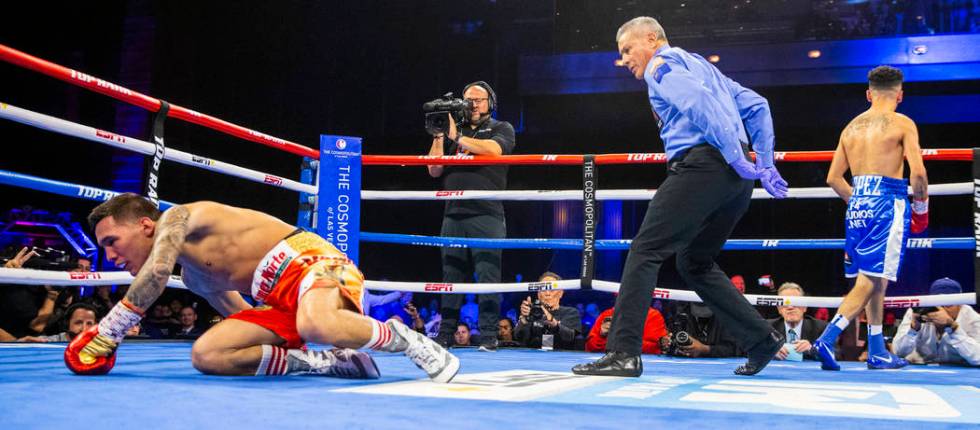 Oscar Valdez, left, is on the canvas after a shot from Adam Lopez during round 2 of their WBC s ...