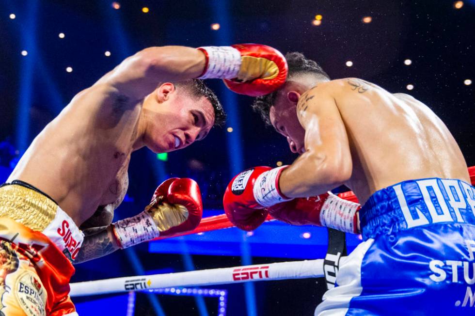 Oscar Valdez, left, connects with an overhand right on Adam Lopez during round 3 of their WBC s ...