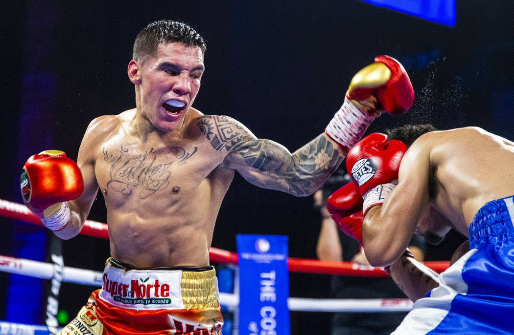 Oscar Valdez, left, readies to strike Adam Lopez again during round 6 of their WBC super feathe ...