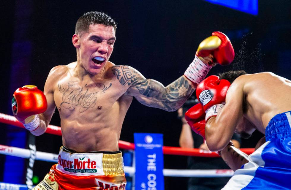 Oscar Valdez, left, readies to strike Adam Lopez again during round 6 of their WBC super feathe ...