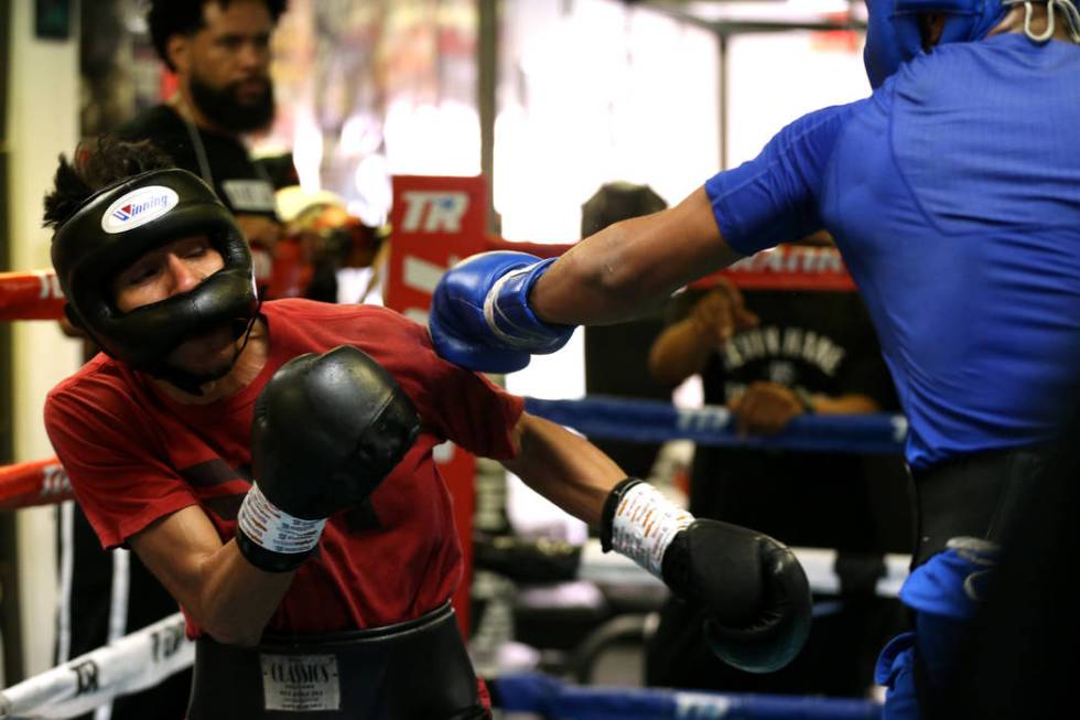 Boxer Devin Haney, right, connects a punch against Cesar Valenzuela while sparring in preparati ...