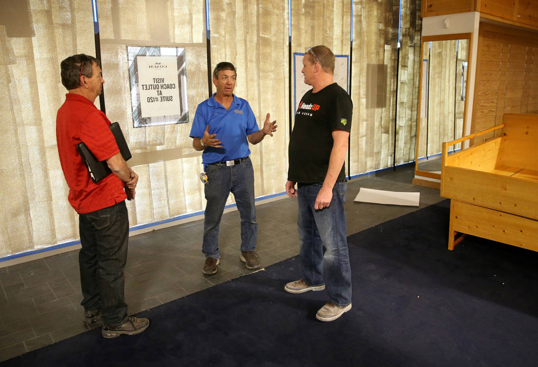 Rick Gibson, left, and Vic Gibson, center, of Dream Themes talk to project manager Darrell Reha ...