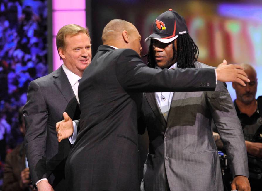 Virginia Tech running back Ryan Williams, right, hugs former defensive back Aeneas Williams as ...