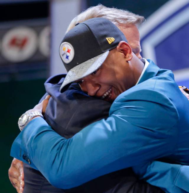 Ohio State outside linebacker Ryan Shazier hugs NFL commissioner Roger Goodell after being sele ...