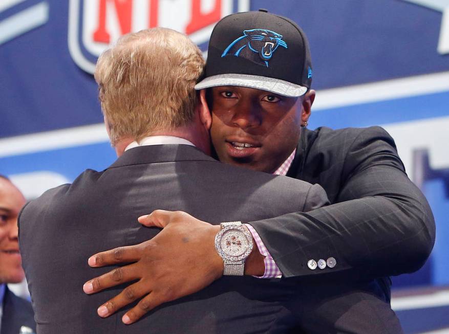 Missouri defensive end Kony Ealy hugs NFL commissioner Roger Goodell after being selected as th ...