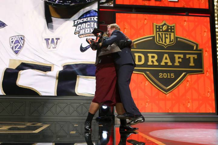 Washington defensive lineman Danny Shelton hugs NFL Commissioner Roger Goodell on stage after ...