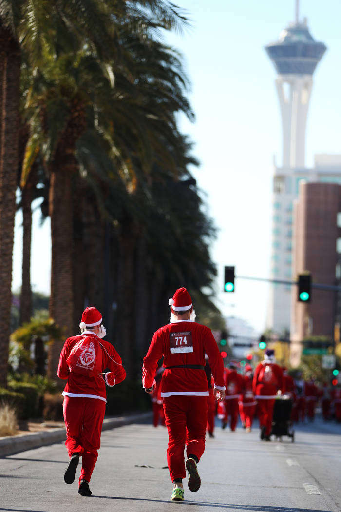 People run in the 14th annual Las Vegas Great Santa Run in downtown Las Vegas, Saturday, Dec. 1 ...