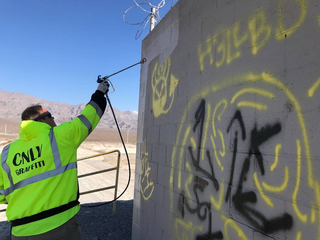 Graffiti Crew Leader Scott Nichols sprays over graffiti. (Alex Chhith/Las Vegas Review-Journal)