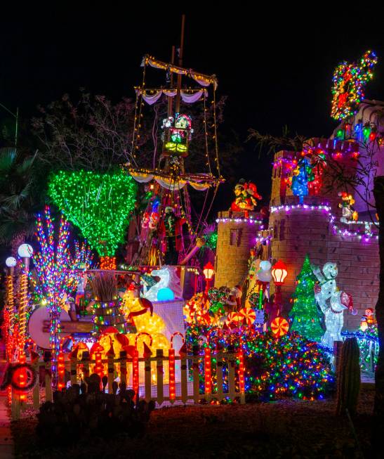 A pirate ship and castle anchor the holiday lights display in the yard of Maria Acosta and Juan ...